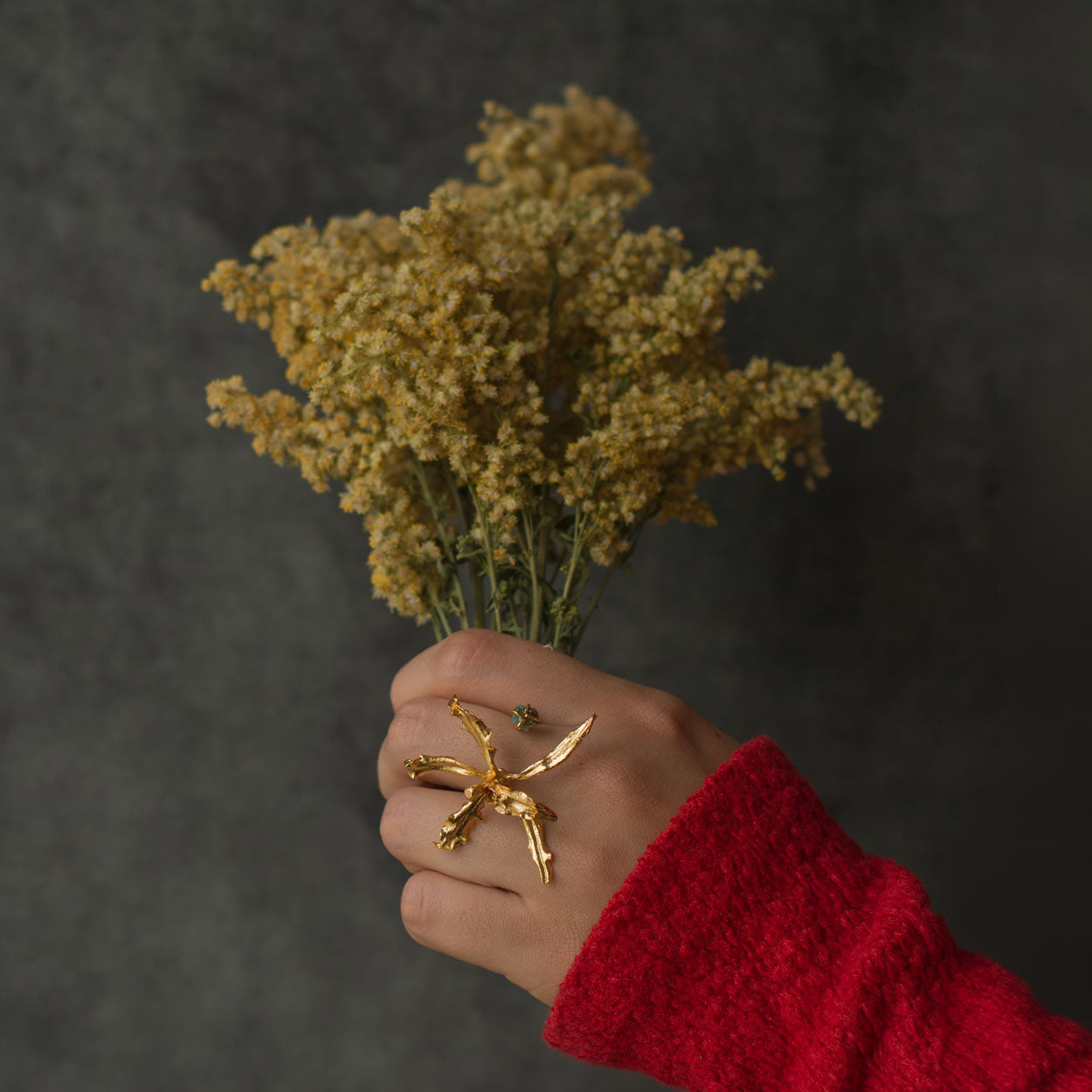 Model wearing Cyrtochilum Revolutum Orchid Ring, emphasizing its unique nature-inspired elegance.