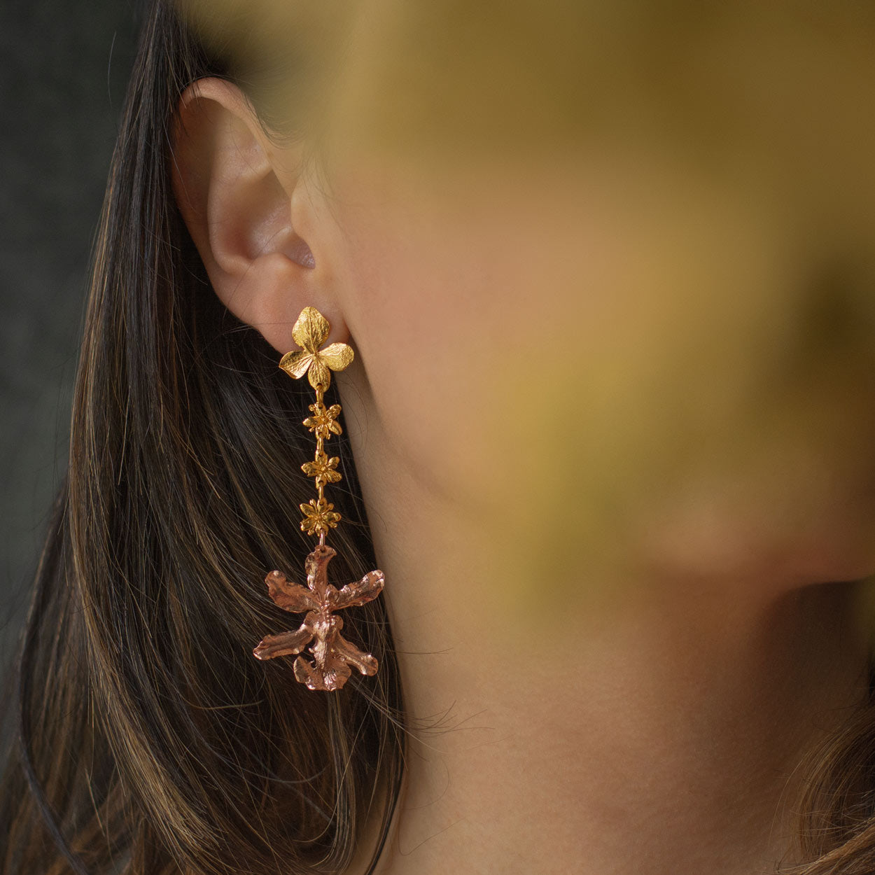 Woman wearing Sharry Baby Orchid Earrings with hydrangea and elderflower details, showcasing their natural, artisanal beauty.
