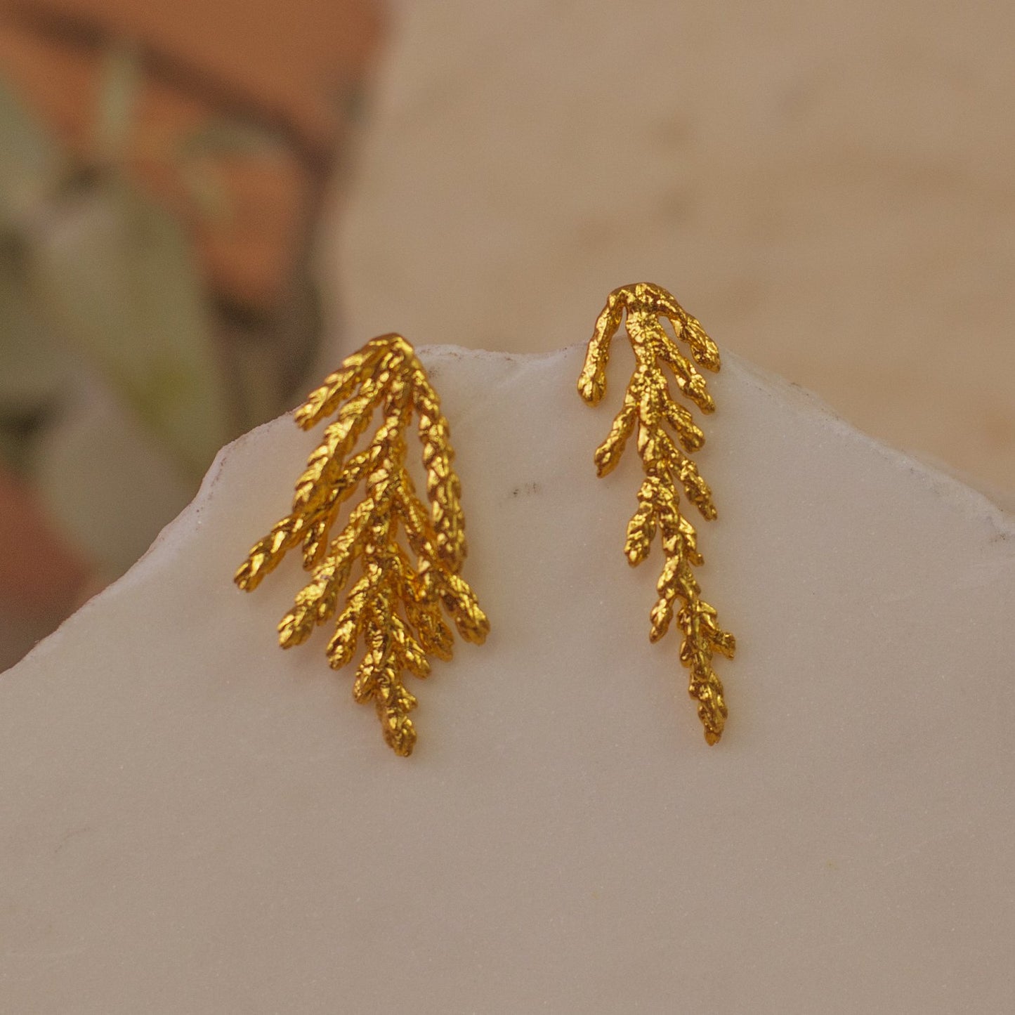Close-up of Pine Leaf Stud Earrings, highlighting the preserved leaf texture and 24k gold plating.
