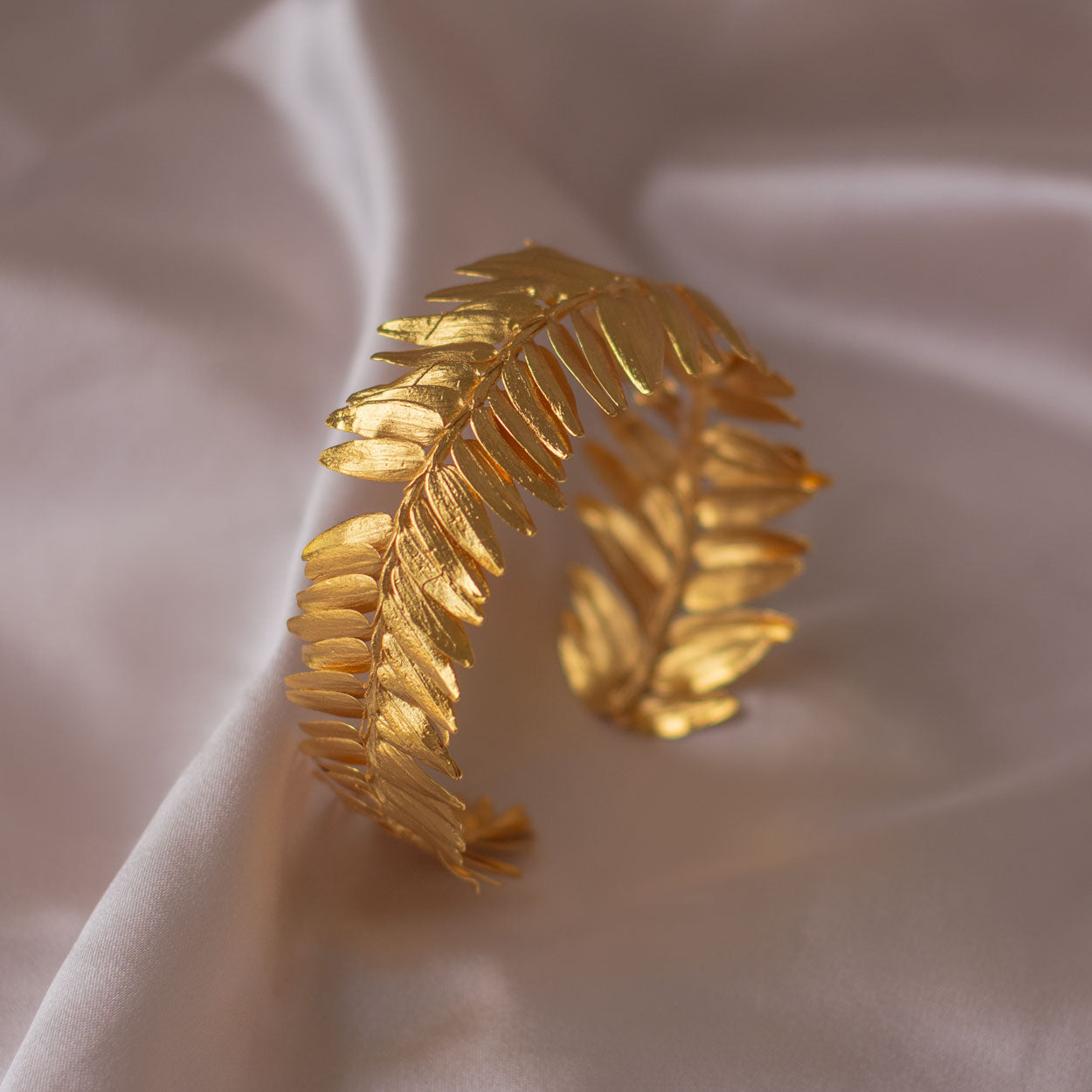 Elegant Roseron Pine Leaf Fern Bracelet in 24K gold plating, capturing the serene beauty of the forest in a luxurious design