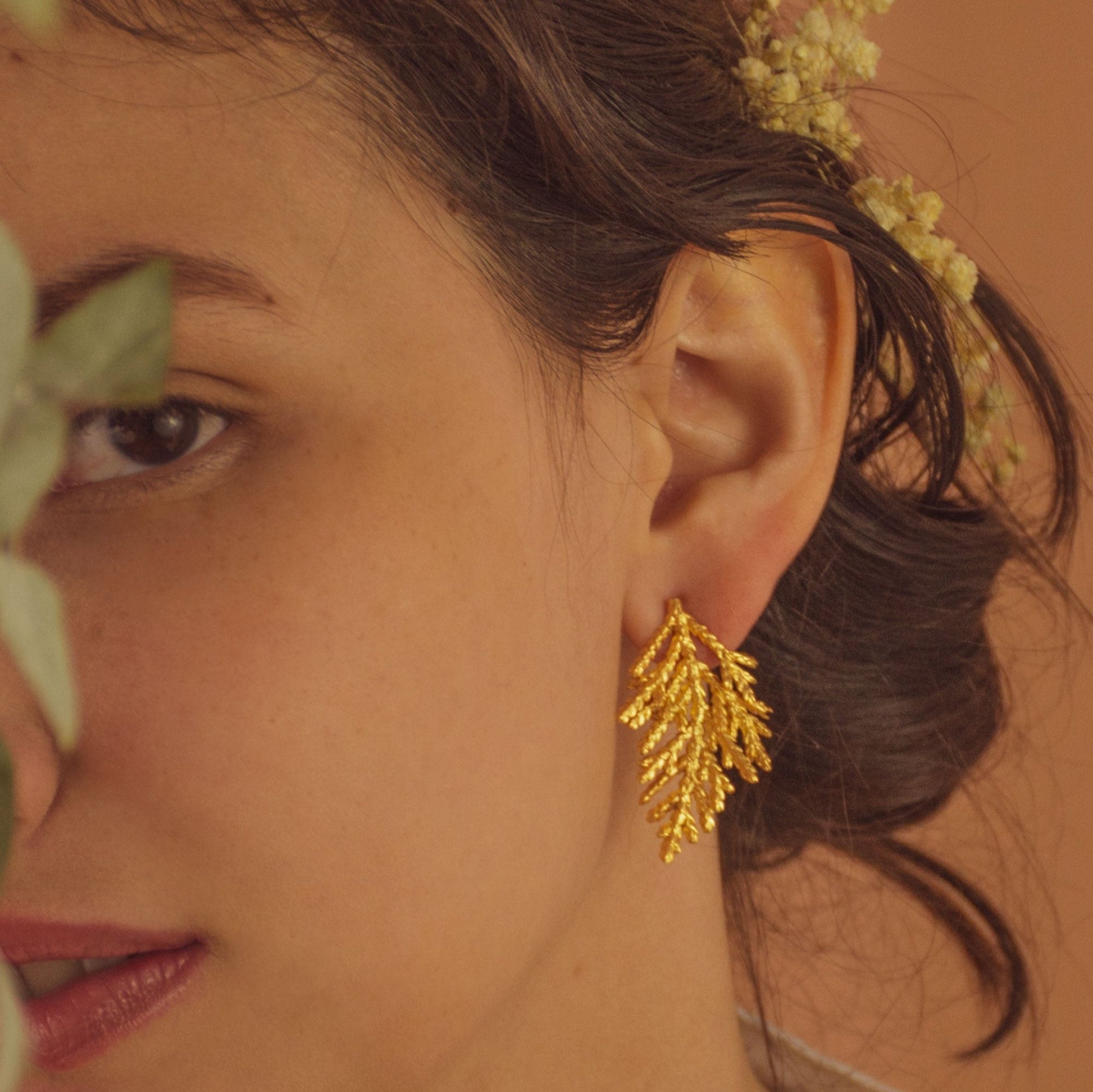 Model wearing Pine Leaf Stud Earrings, showcasing their elegant and nature-inspired design.