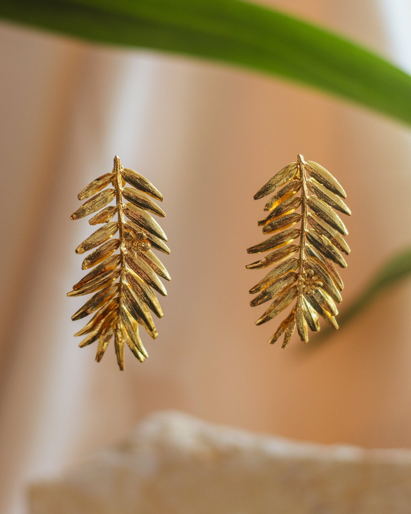 Close-up of Romeron Pine & Elderflower Earrings, highlighting the intricate details of the preserved foliage.