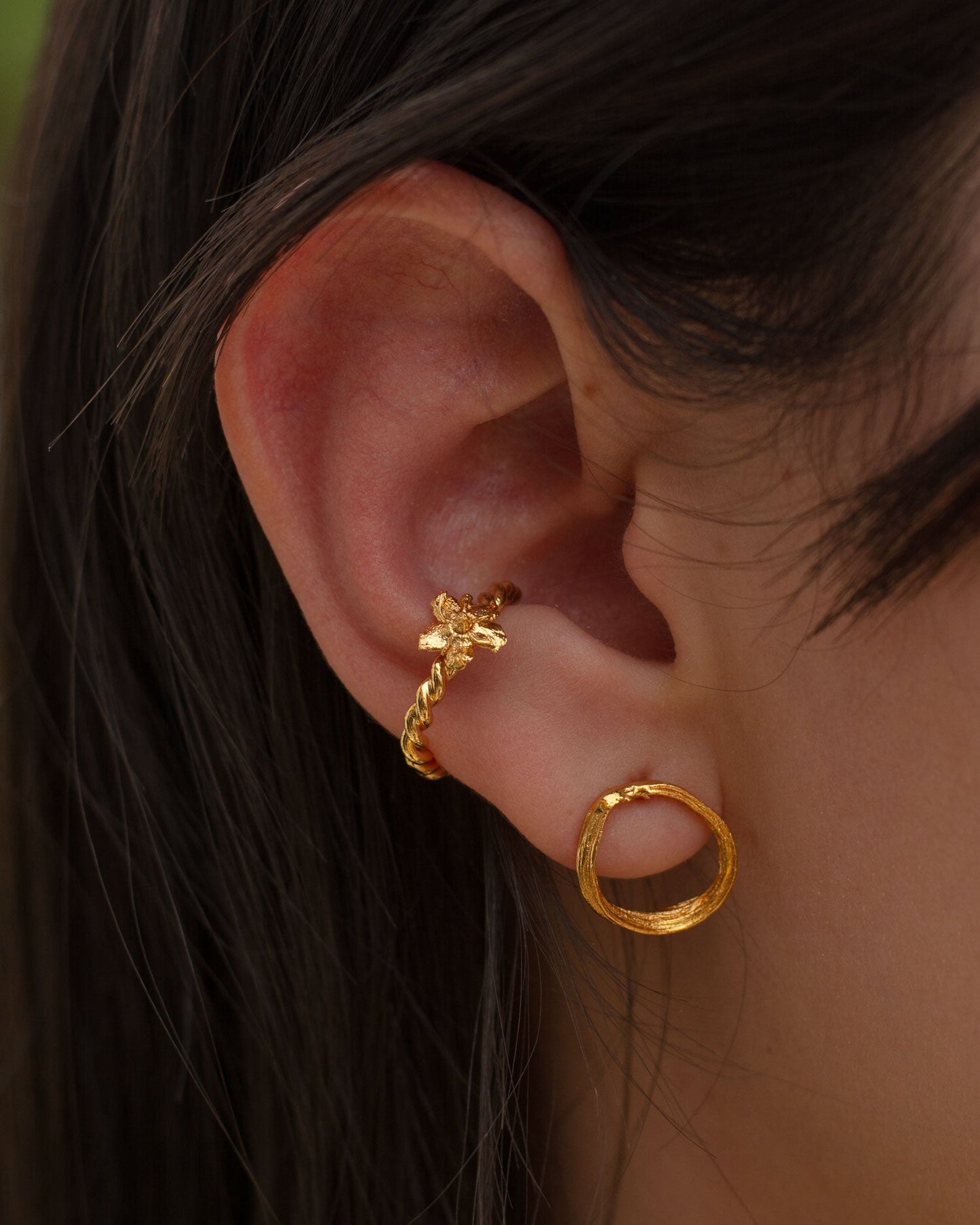 Side view of a model wearing the Anthurium Twig Hoop Stud Earrings, highlighting their natural elegance and unique design.