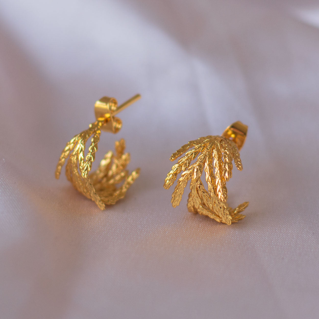 Dainty Pine Leaf Hoop Earrings, handcrafted in bronze with 24k gold plating, featuring natural pine leaf designs for an elegant, nature-inspired look