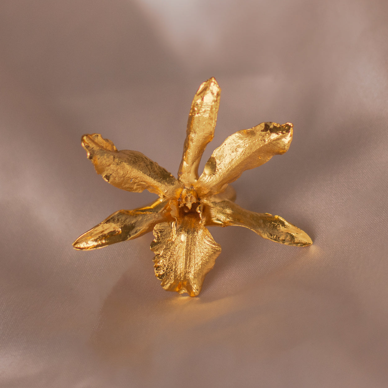 Cherry Rain Orchid Ring crafted in bronze with 24k gold plating, highlighting the delicate details of the orchid flower