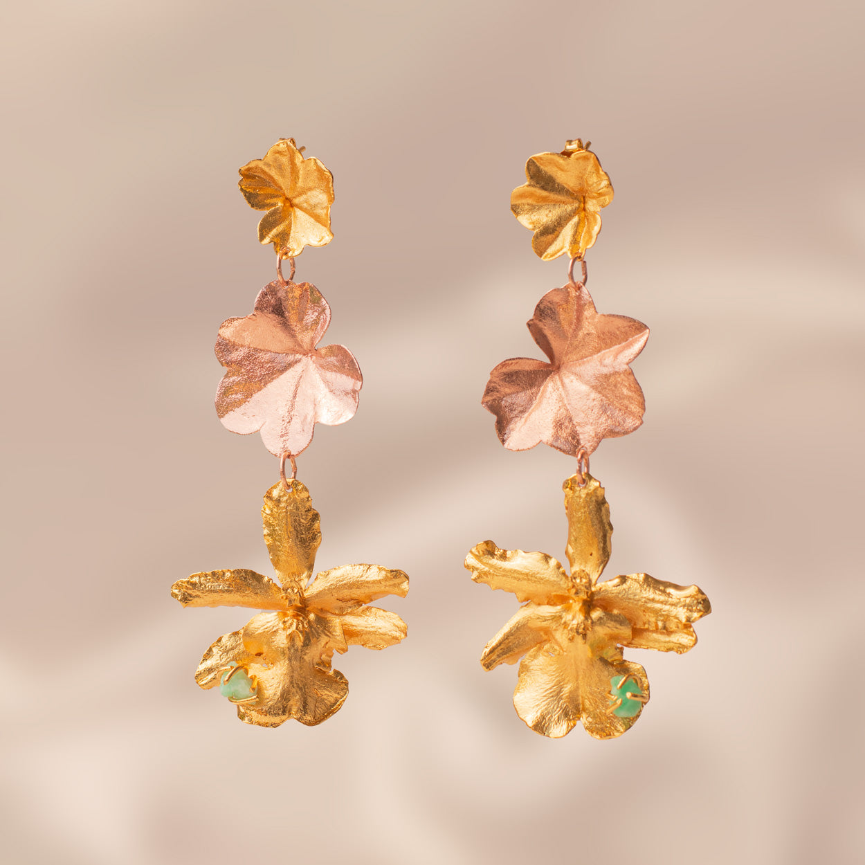 Detailed view of handcrafted Odontoglossum Orchid Ivy Leaf Emerald Earrings, featuring organic shapes and Colombian emerald accents