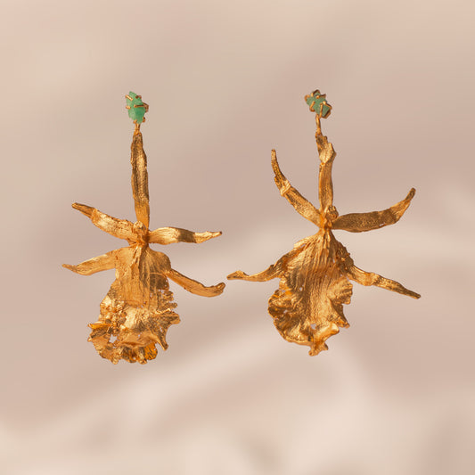 Brassia Orchid Earrings with pine leaves, elderflowers, and raw emeralds, plated with 24k gold.
