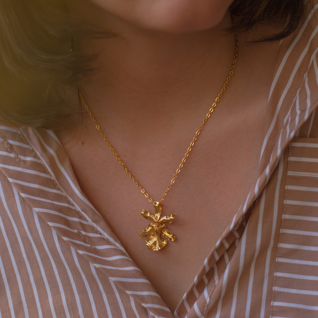 Model wearing the Oncidium Sharry Baby Orchid Necklace, highlighting the natural elegance and sophistication of the design