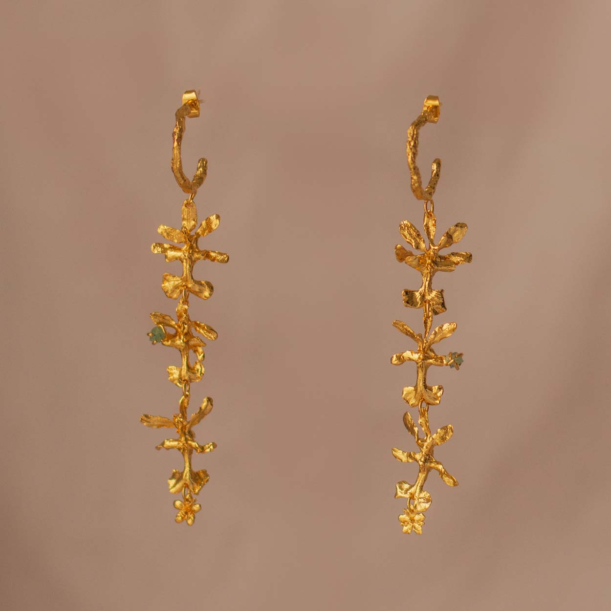 Three Oncidium Orchid Emerald Hoops displayed on a natural background, highlighting the unique blend of nature and luxury