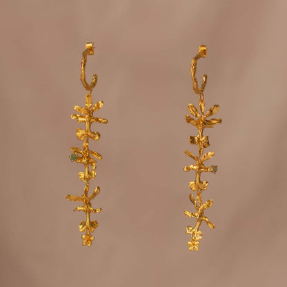 Three Oncidium Orchid Emerald Hoops displayed on a natural background, highlighting the unique blend of nature and luxury