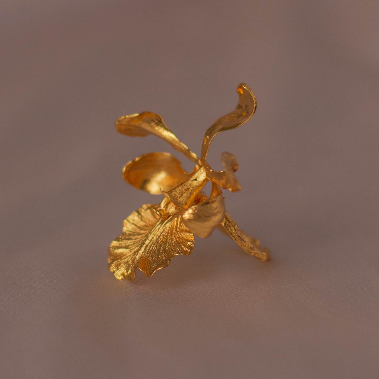 Close-up of Encyclia Cordigera Ring showing the intricate details of the orchid preserved in gold.
