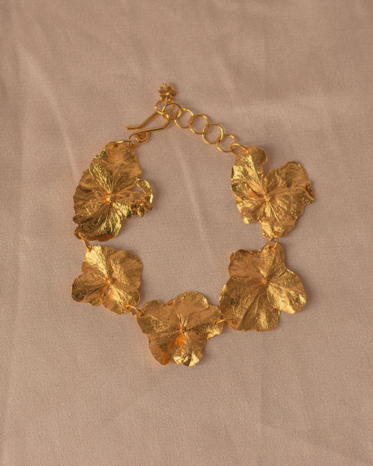 Close-up of Five Hydrangea Flower Bracelet in 24k gold, showing detailed floral textures and artisanal craftsmanship.