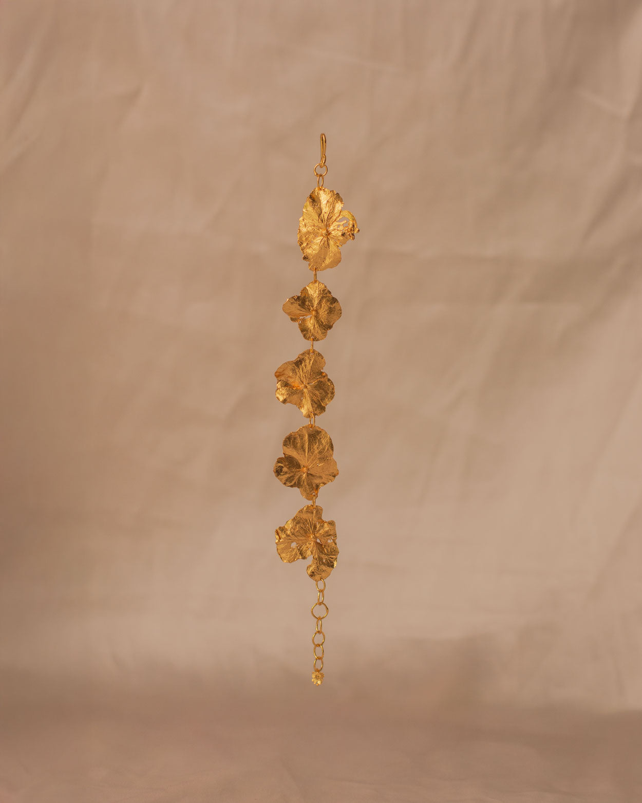 Elegant wrist wearing Five Hydrangea Flower Bracelet, featuring delicate floral design in gold.