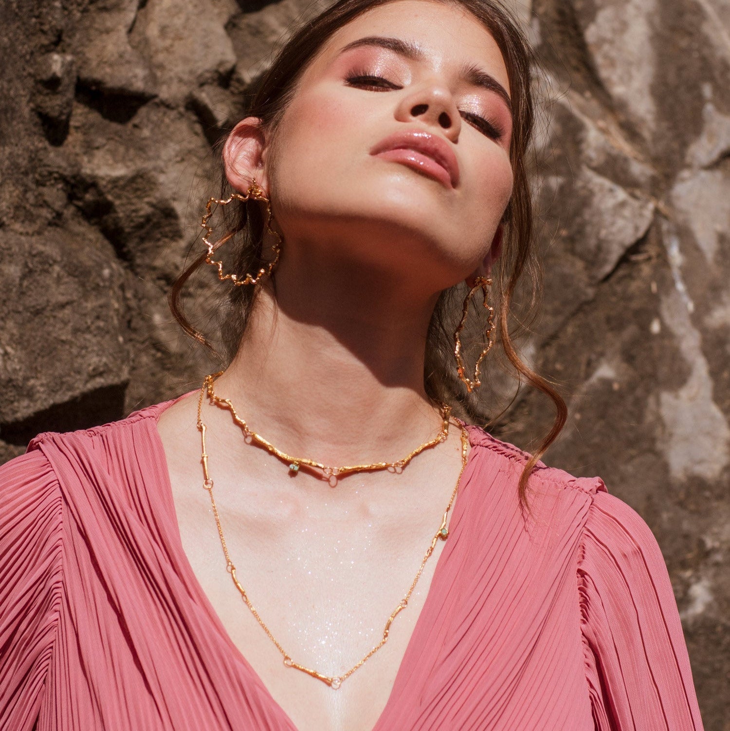 Collar Ramitas Eucalipto Esmeraldas en bronce bañado en oro de 24k, destacando las delicadas ramitas y la brillante morralla de esmeraldas.