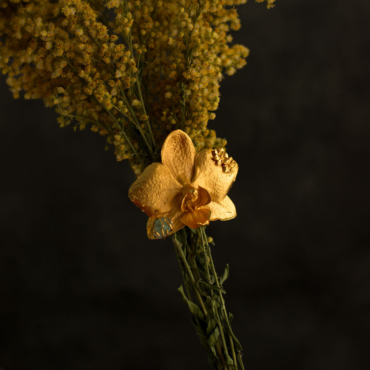 Artisanal Phalaenopsis Orchid Elderflower Emerald Ring on a jewelry display, emphasizing the natural beauty and luxury finish of the piece