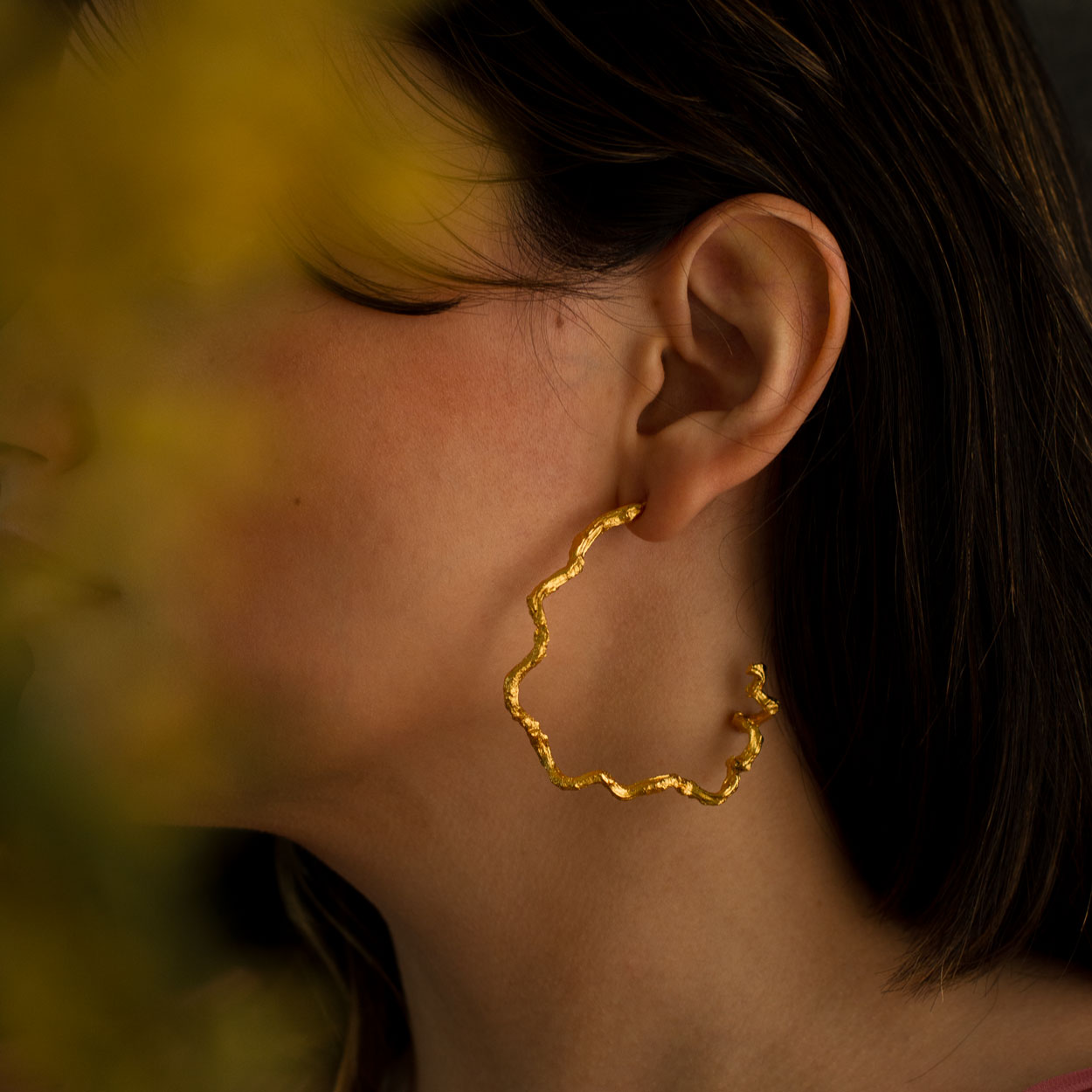 Elegant Large Palm Twig Hoop Earrings in 24K gold plating, celebrating the creativity of nature and artisanal craftsmanship.