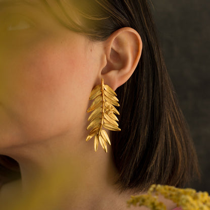 Model wearing Romeron Pine & Elderflower Earrings, showcasing the blend of natural elegance and luxury.
