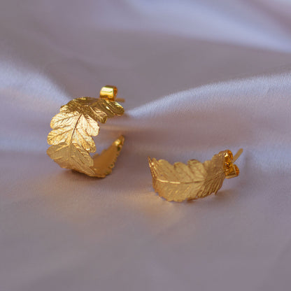 Cinnamon Fern Hoop Earrings, handcrafted in bronze with 24k gold plating, featuring delicate fern leaf designs for an eco-friendly and natural look