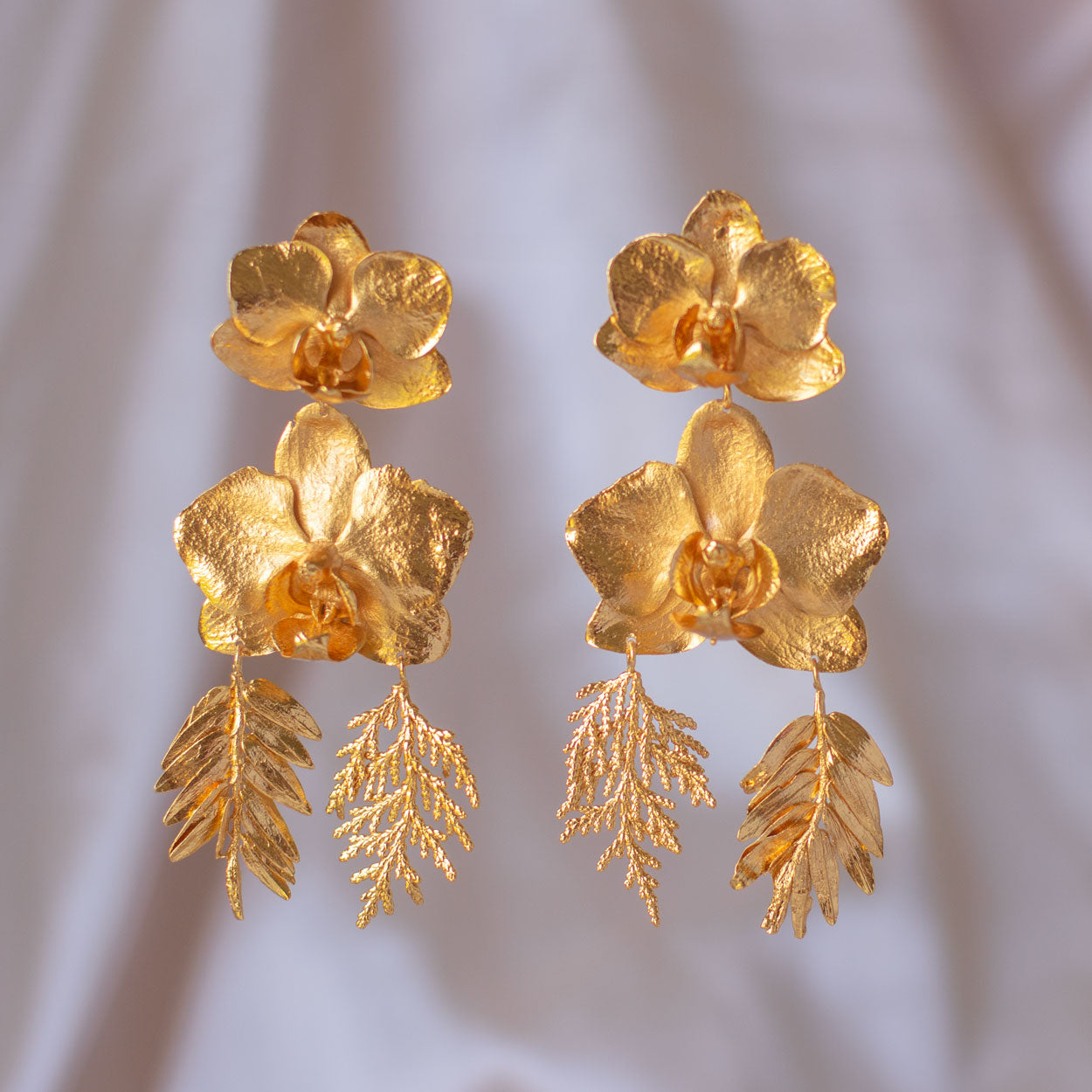 Elegant Phalaenopsis Orchids and Leaves Earrings in 24K gold, embodying botanical elegance and a profound connection to the earth