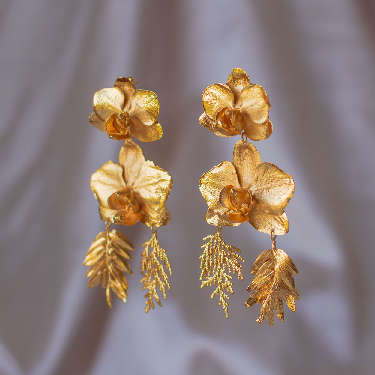 Elegant Phalaenopsis Orchids and Leaves Earrings in 24K gold, embodying botanical elegance and a profound connection to the earth