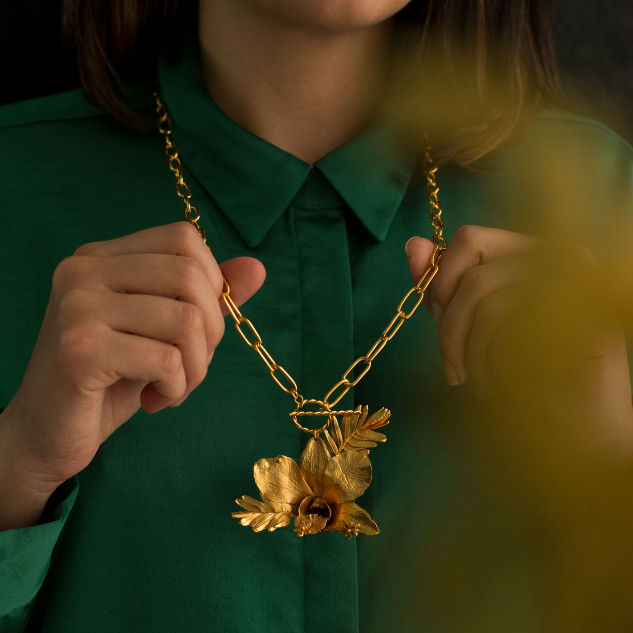 Luxurious Dendrobium Orchid Necklace with gold plating, capturing the exotic elegance of nature in every detail.