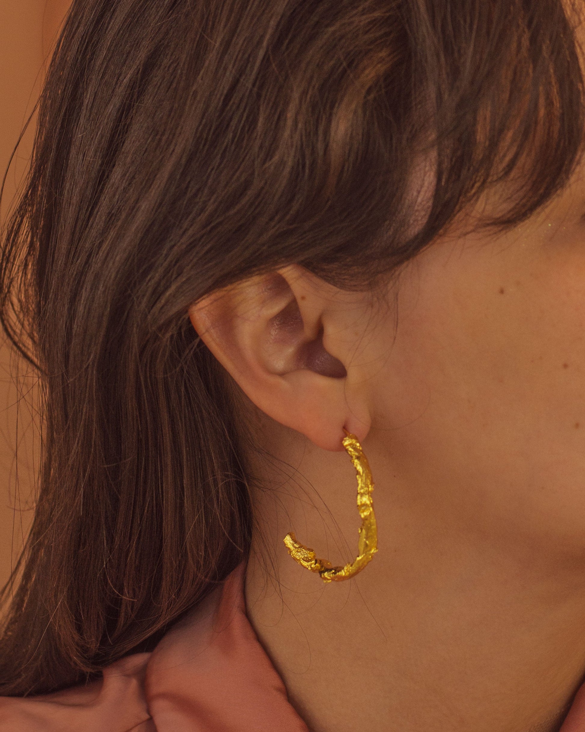 Elegant Large Palm Twig Hoop Earrings in 24K gold plating, celebrating the creativity of nature and artisanal craftsmanship.