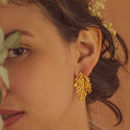 Model wearing Pine Leaf Stud Earrings, showcasing their elegant and nature-inspired design.
