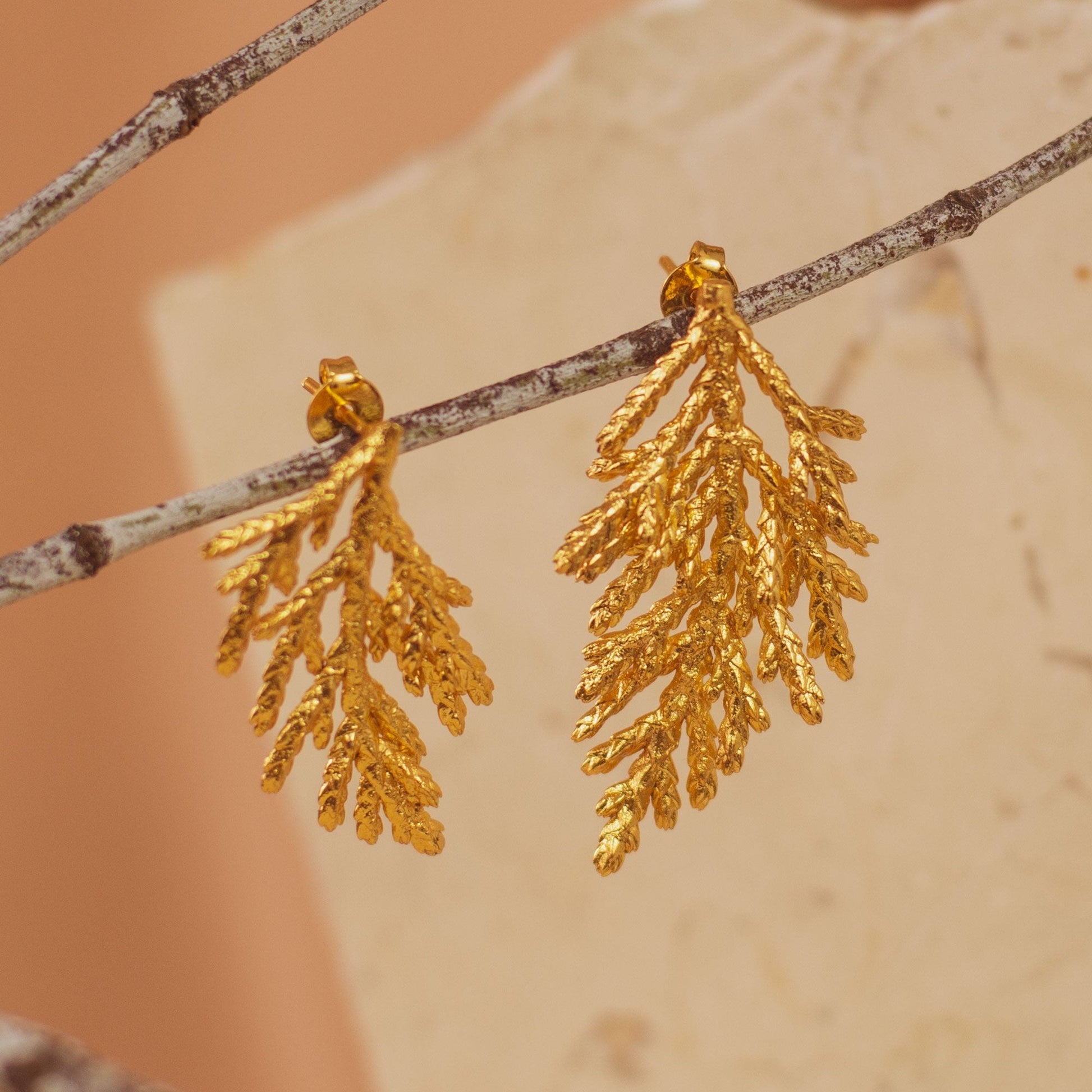 Pine Leaf Stud Earrings in 24k gold, featuring a natural pine leaf design.
