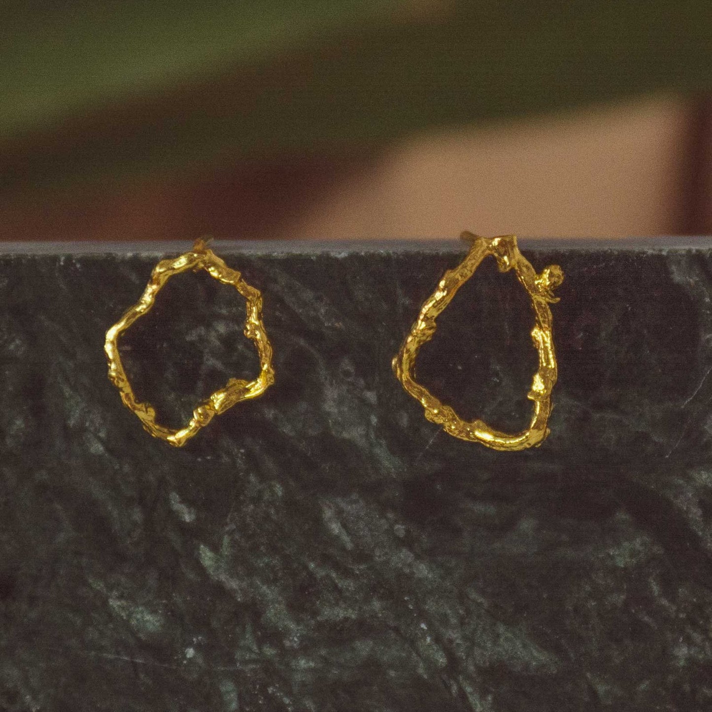 Twig Hoop Stud Earrings with 24k gold-plated coconut palm twigs in a circular design.
