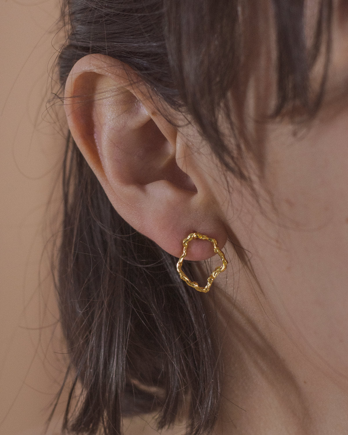 Model wearing Twig Hoop Stud Earrings, highlighting the circular shape and natural elegance.
