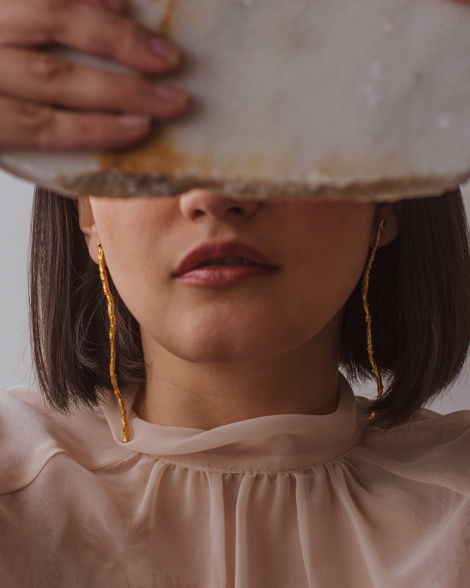 Model wearing Coconut Palm Twig Earrings, emphasizing their unique, nature-inspired design.
