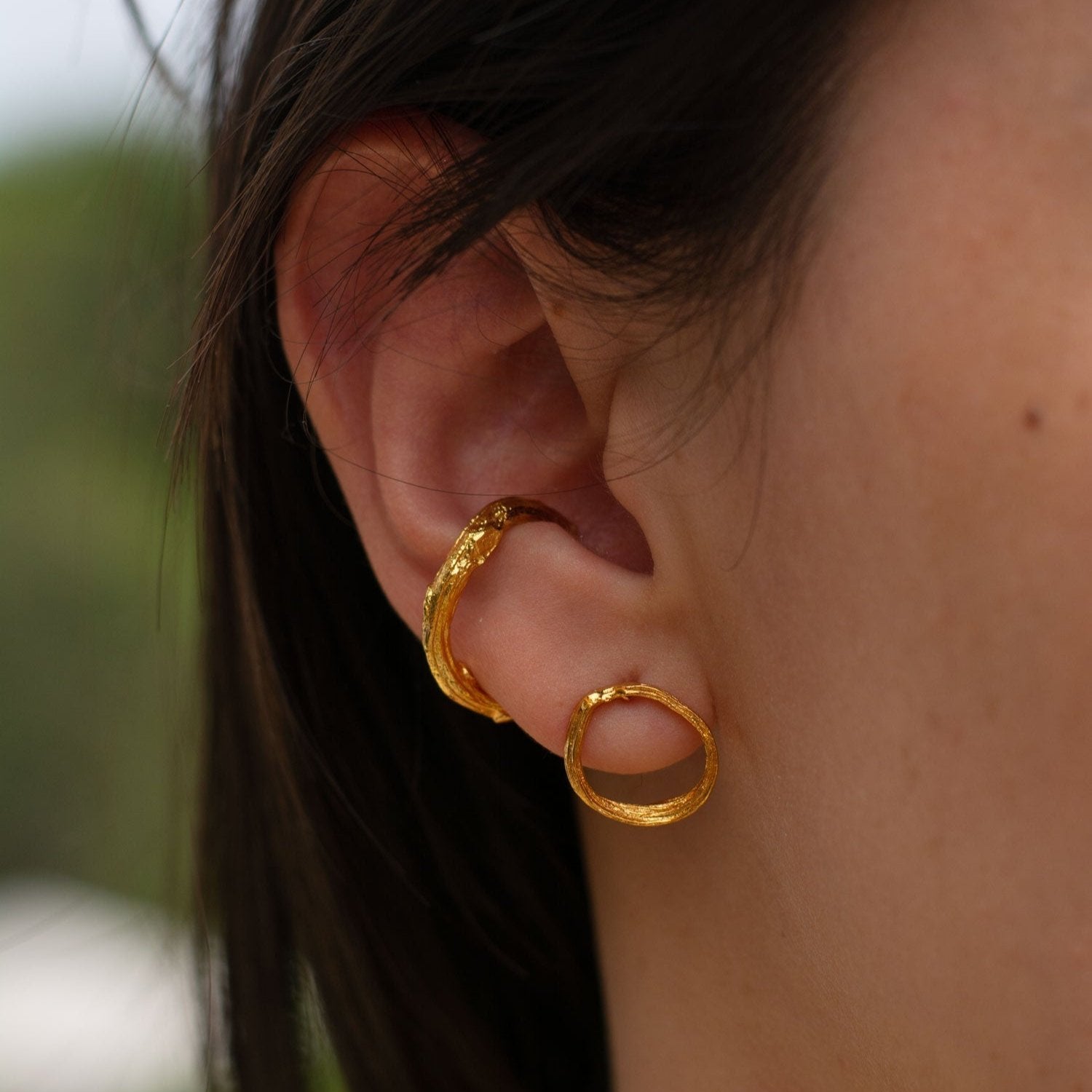 Handmade medium earcuff featuring palm twigs, plated in 24k gold, highlighting a unique and sophisticated look.