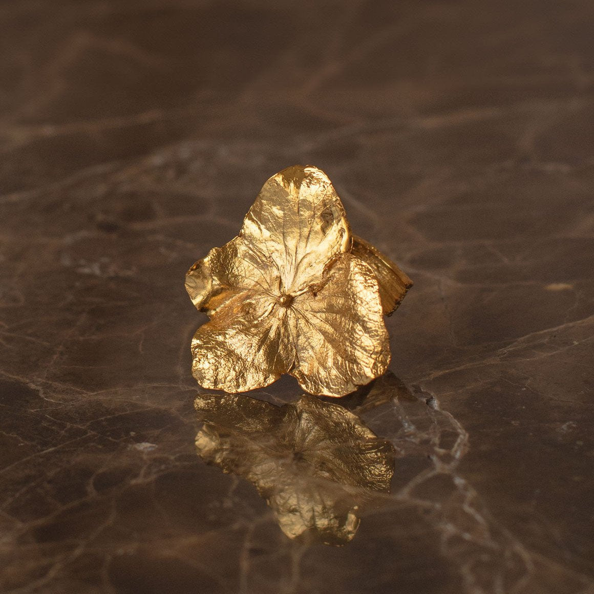 Hydrangea Ring featuring real flowers and twigs, preserved in bronze with a 24k gold finish.
