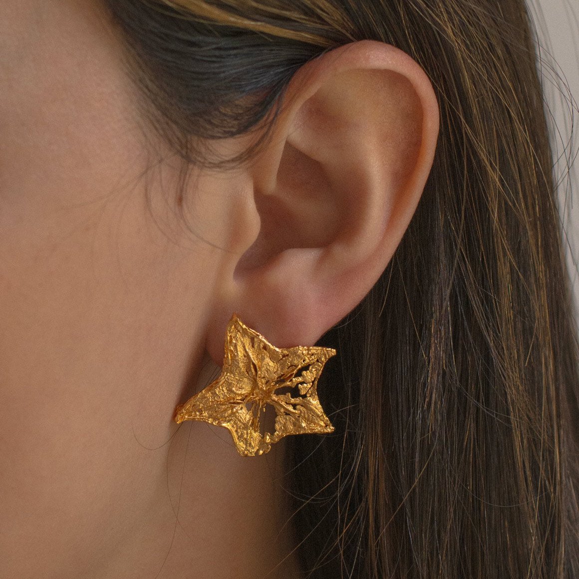 Model wearing Starfruit Slice Stud Earrings, highlighting the natural beauty and unique design.
