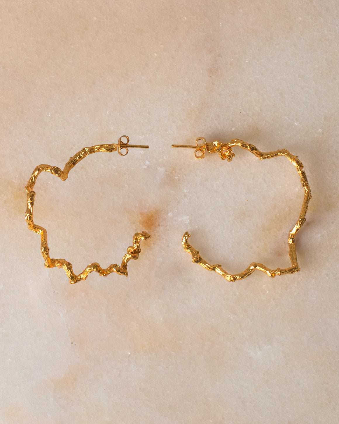 Elegant Large Palm Twig Hoop Earrings in 24K gold plating, celebrating the creativity of nature and artisanal craftsmanship.