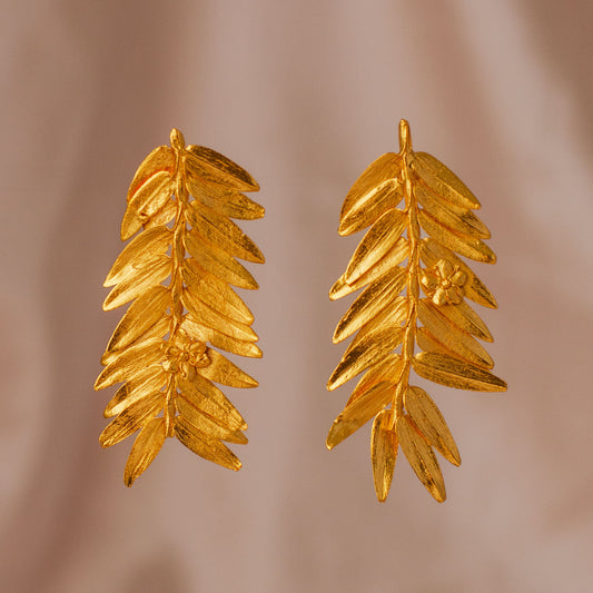 Romeron Pine & Elderflower Earrings with 24k gold-plated natural leaves and flowers.
