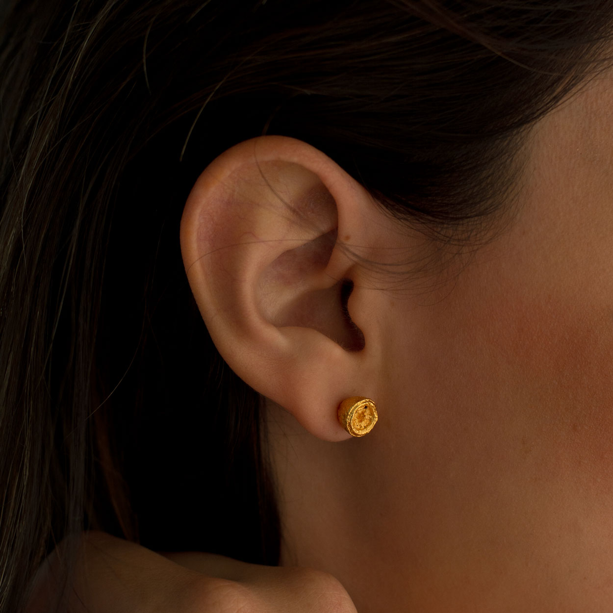 Close-up of Eucalyptus Seed Stud Earrings, showcasing the natural shape and texture of the seeds with a luxurious 24k gold plating