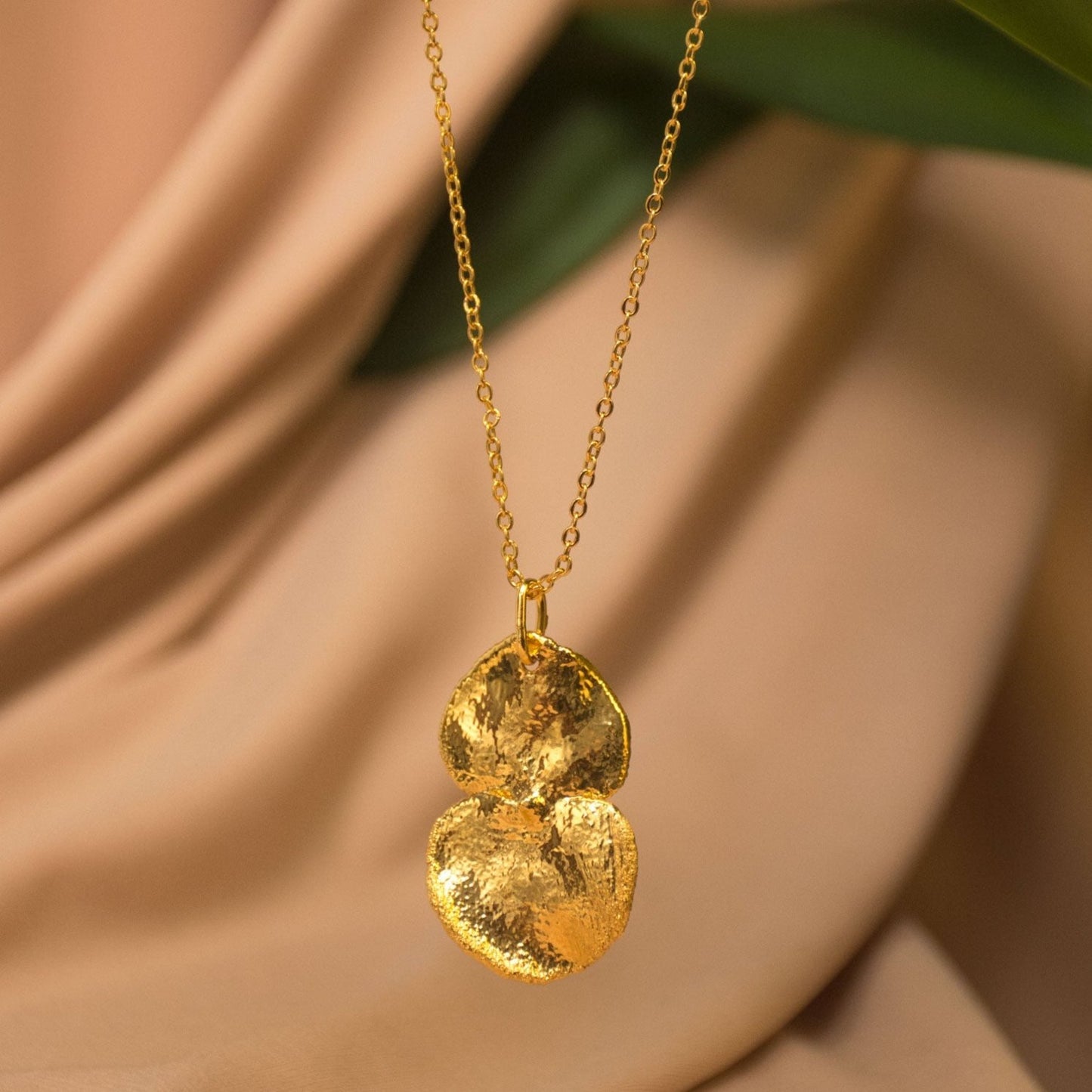 Eucalyptus Leaf Necklace, handcrafted in bronze and plated with 24k gold, featuring a natural eucalyptus leaf design for a fresh, elegant look