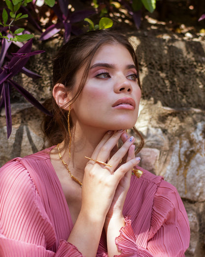 Model wearing Coconut Palm Twig Earrings, emphasizing their unique, nature-inspired design.
